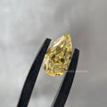 Close-up of the 1.02 CT pear shaped yellow diamond set in a custom engagement ring