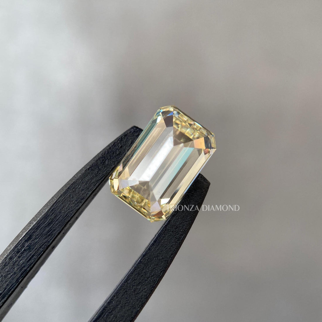 Emerald cut light yellow lab grown diamond showcasing its 1.02 CT fancy color brilliance