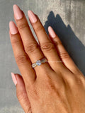 Woman wearing the round diamond anniversary ring, closeup view on her hand