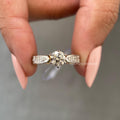 Woman wearing the round diamond solitaire ring, close-up view on her hand
