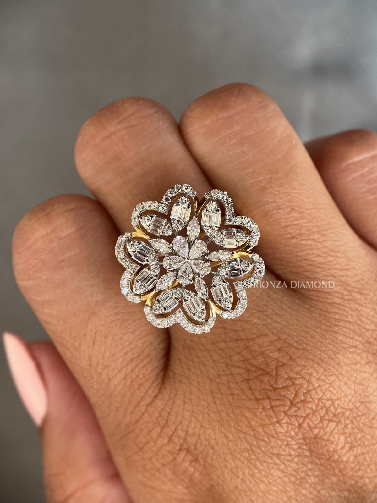 Woman wearing the floral marquise and pear diamond ring on her hand