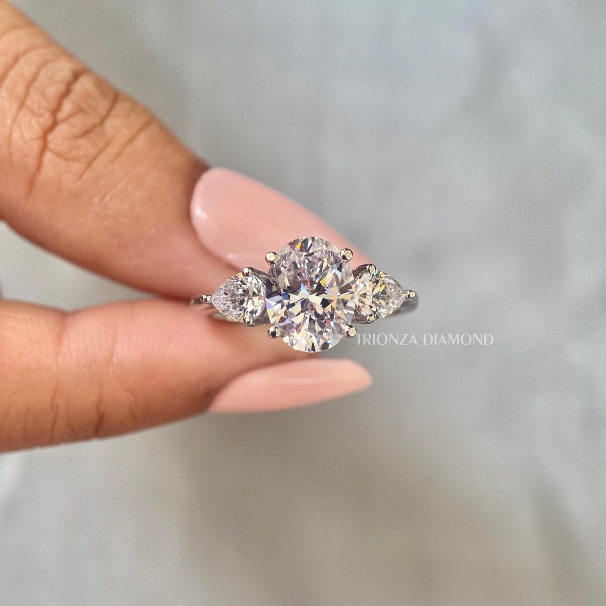 TrionzaDiamond engagement ring crafted with a 2 carat oval diamond for a modern proposal