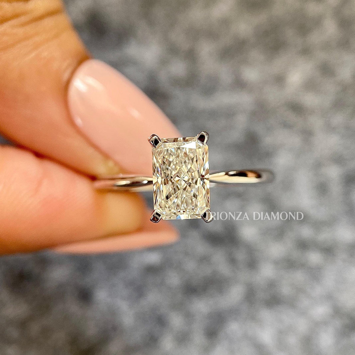 Radiant cut lab grown diamond engagement ring showcasing the elongated solitaire setting in 14k white gold