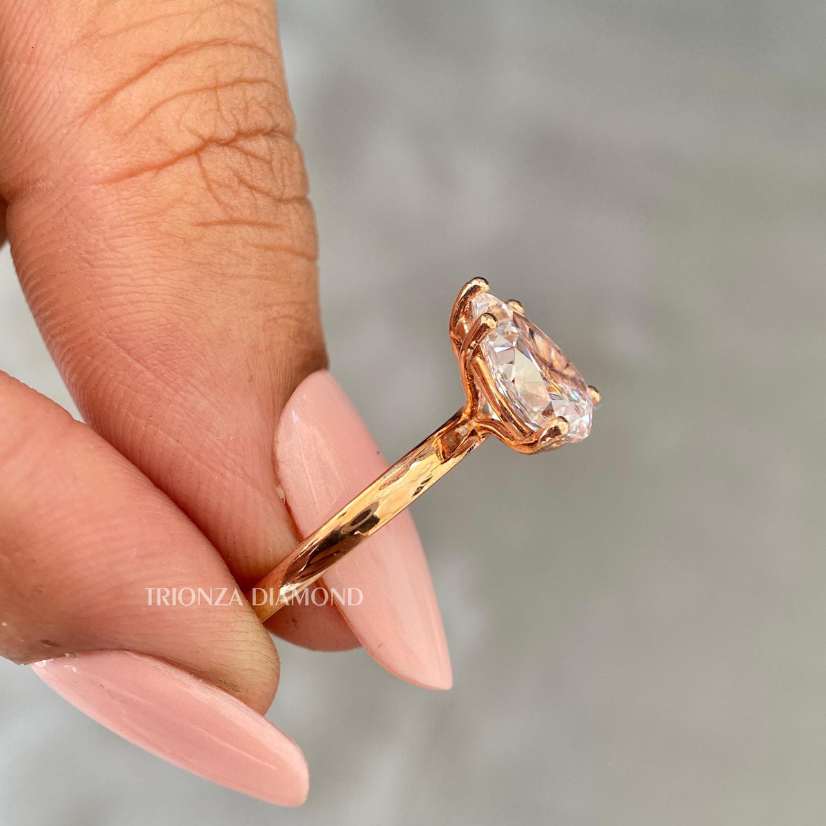 Close-up of the tear drop diamond showing its pear cut facets and clarity