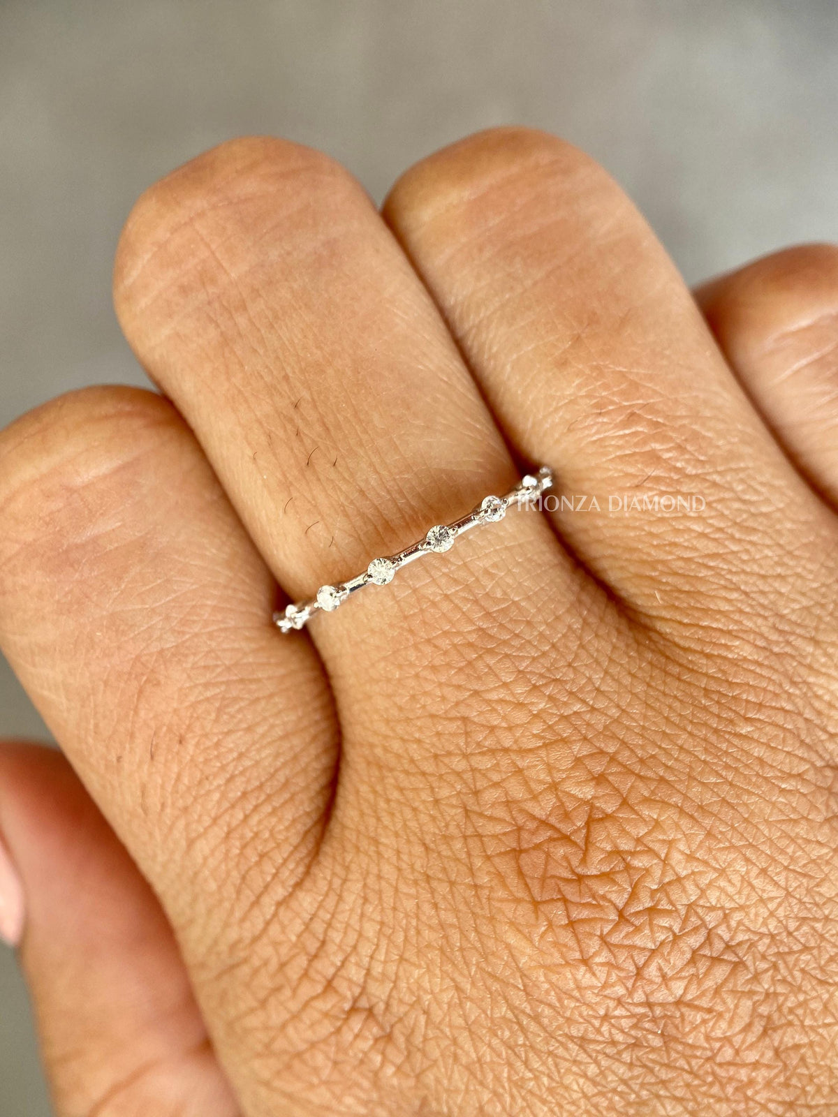 Close-up of the 1.50 MM round diamonds set along the stackable wedding band