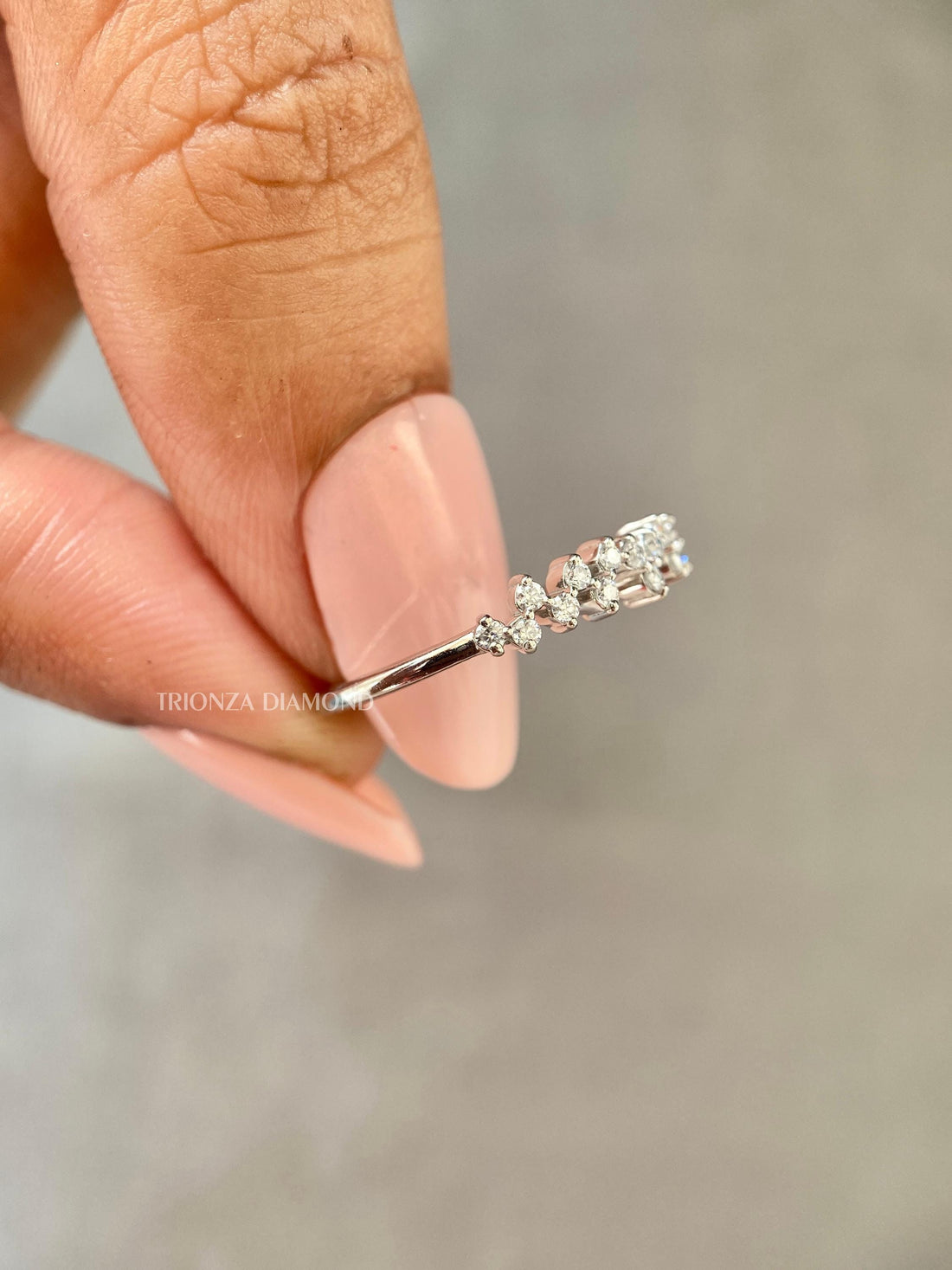 Round cut lab grown diamond half eternity wedding band displayed in a zig zag setting