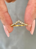 Curved 14k gold wedding band featuring round cut lab grown diamonds set in a thin design
