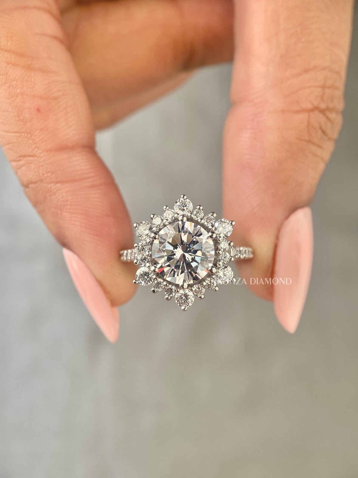 Round lab grown diamond engagement ring featuring a starburst halo and pave band design