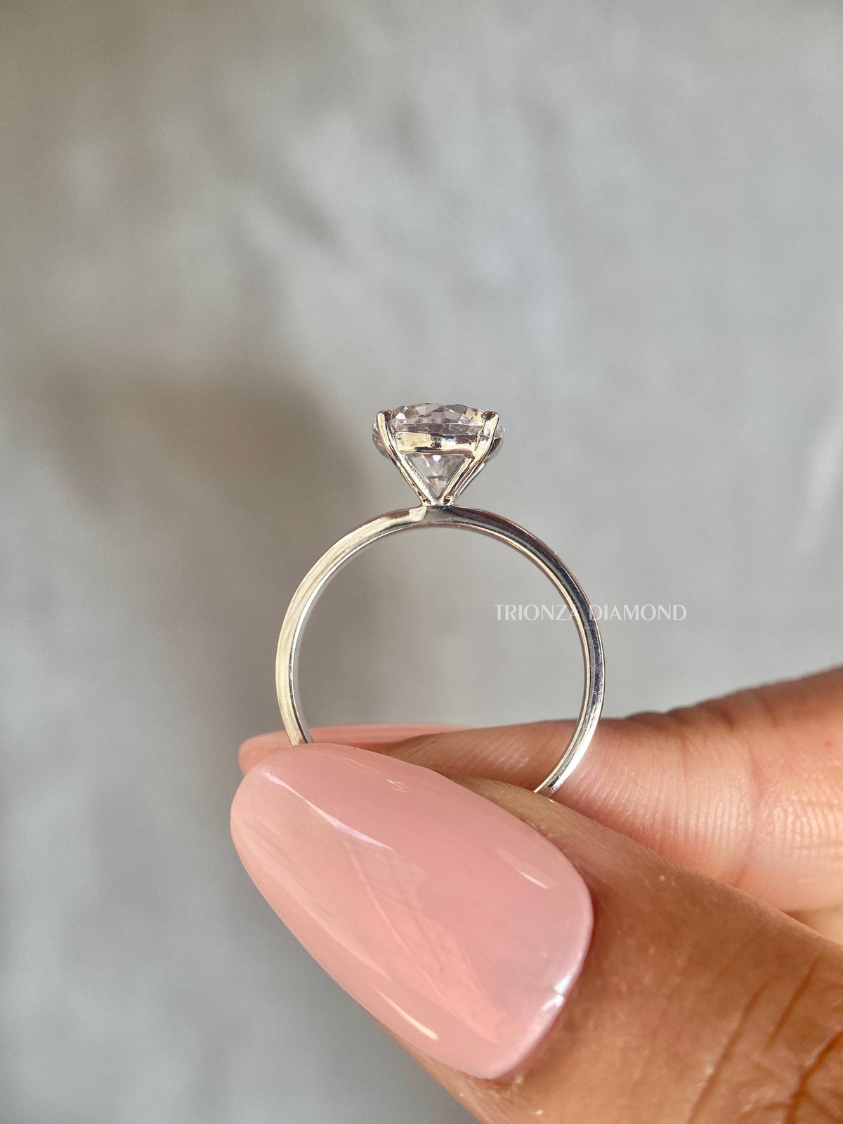 Classic solitaire engagement ring displayed to highlight the polished band design