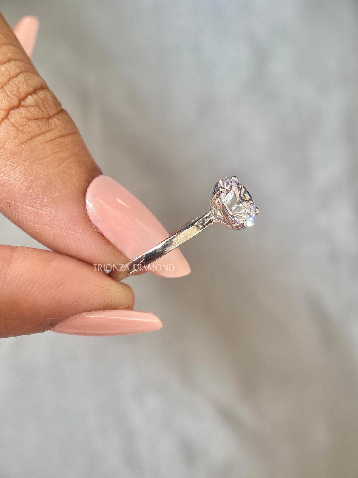 Woman wearing the 2 CT round diamond ring for an elegant everyday look