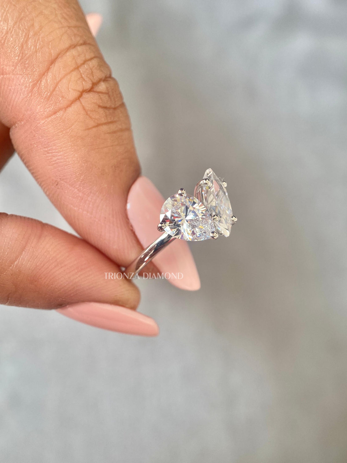 Woman wearing the toi et moi engagement ring, close-up view on her hand