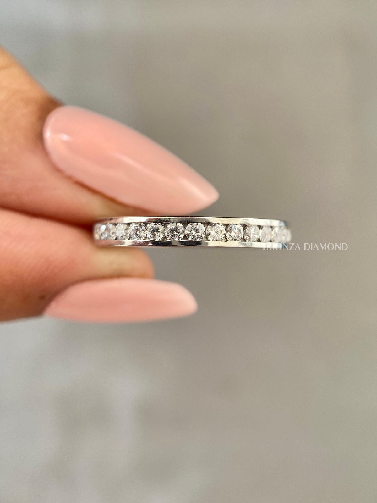 Woman wearing the eco-friendly diamond stackable ring alongside other rings