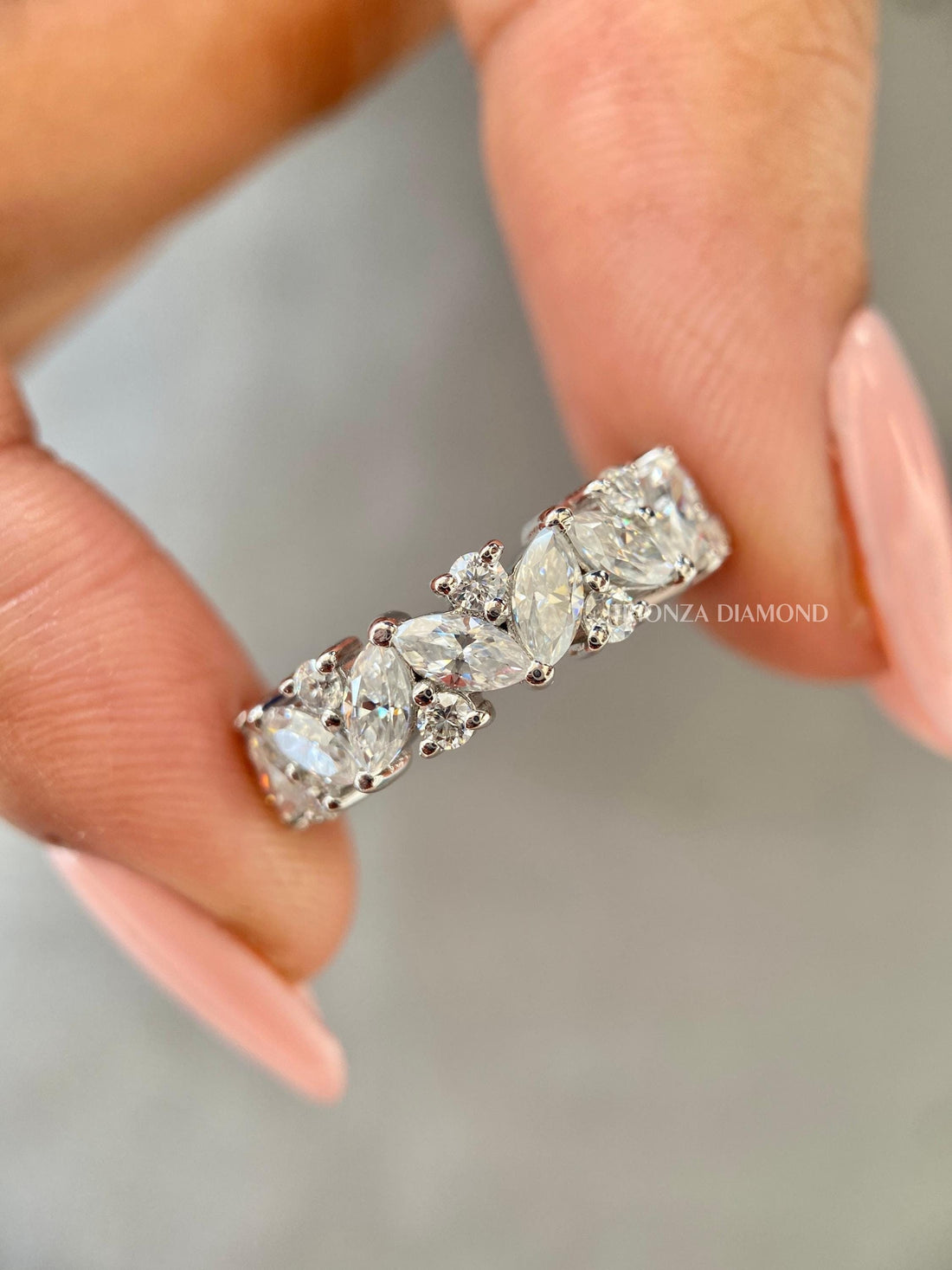 Marquise and round cut lab grown diamond half eternity band shown in a close-up view