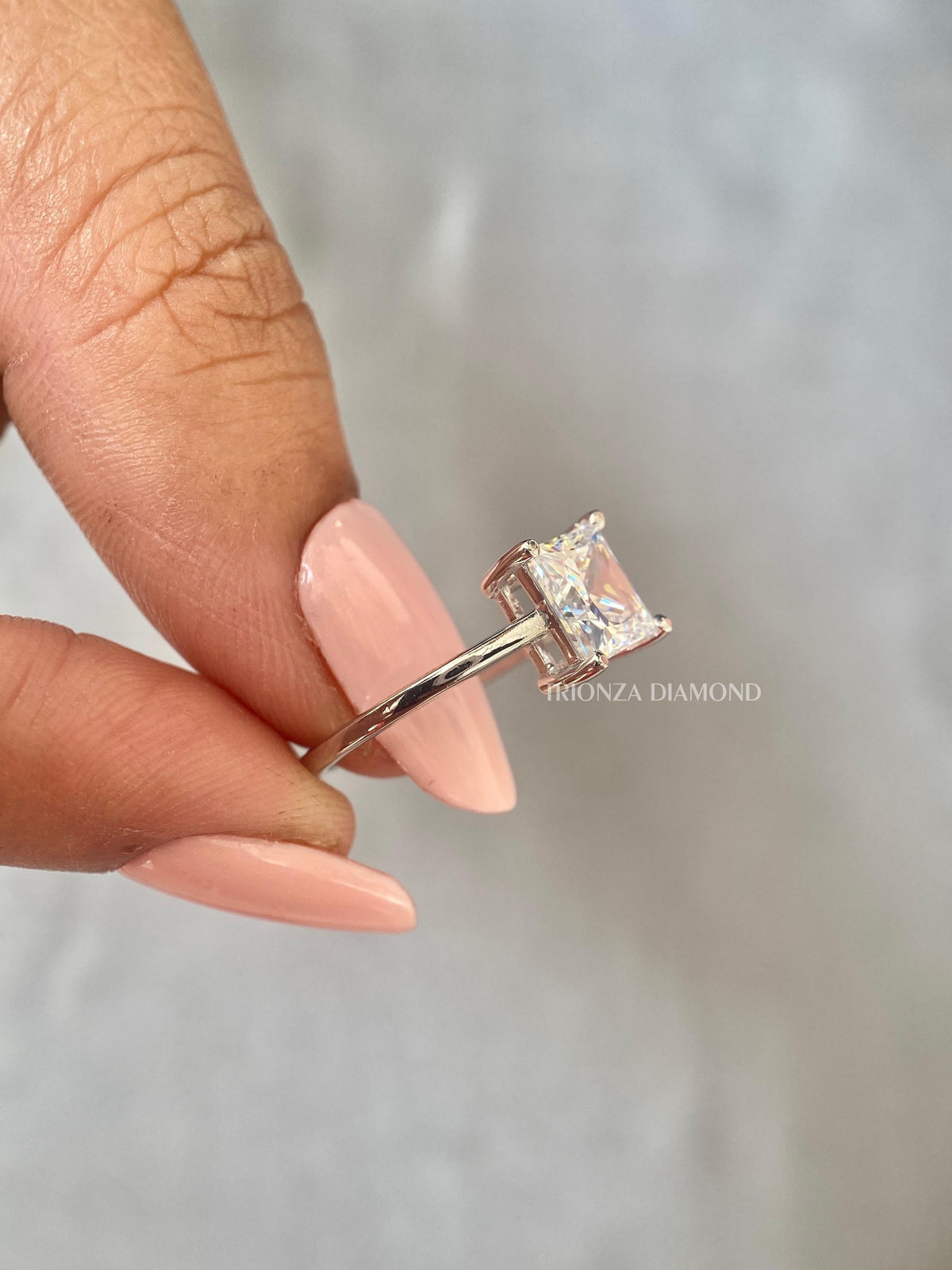 Classic D shape white gold engagement ring featuring a tapered cathedral band design