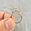 Close-up of the 1 CT round cut center diamond set in a floral gold ring design