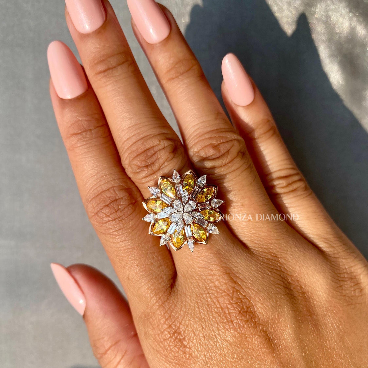 Side view of the pear baguette cut ring highlighting the F color VS1 clarity diamonds