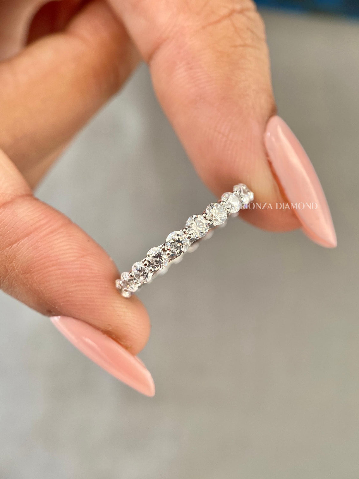 Diamond wedding band for her displayed to highlight the trellis setting details