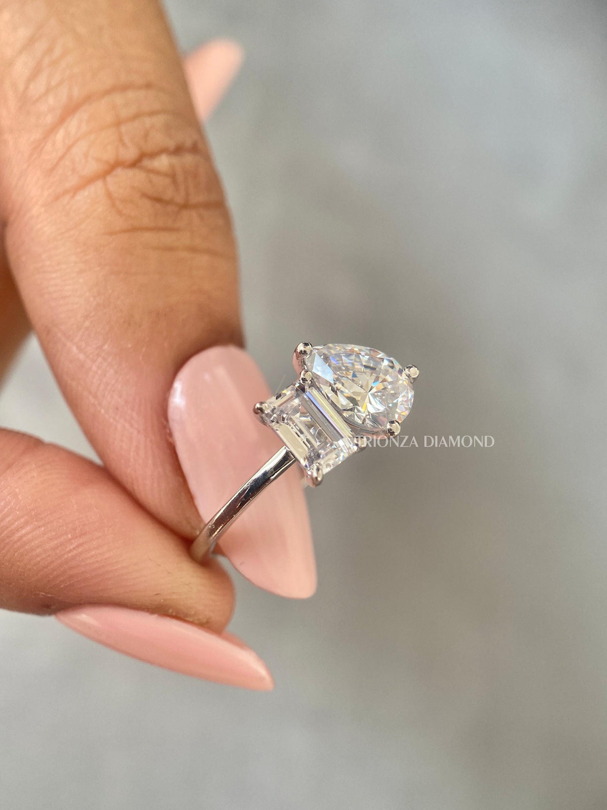 Close-up of the 0.60 CT emerald cut and 2.00 CT pear cut diamonds in the toi et moi setting