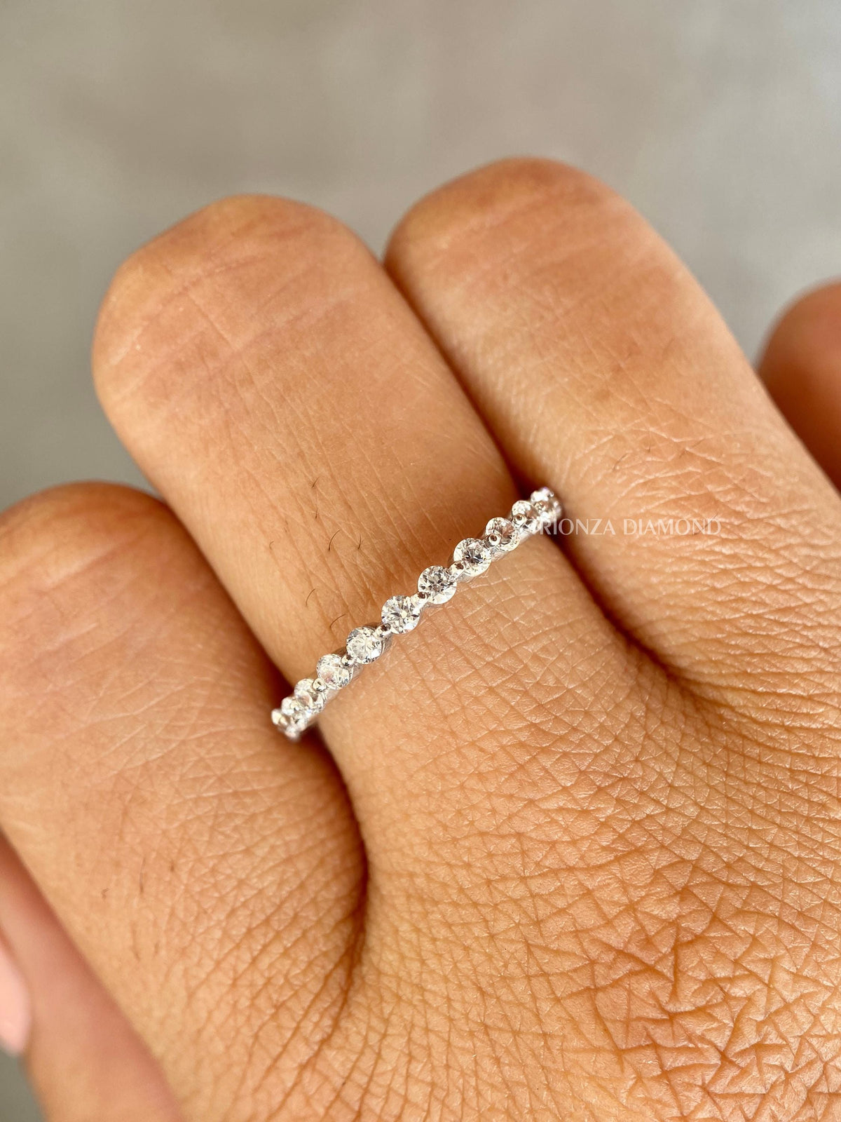 Stackable diamond wedding band designed as a matching band for an engagement ring