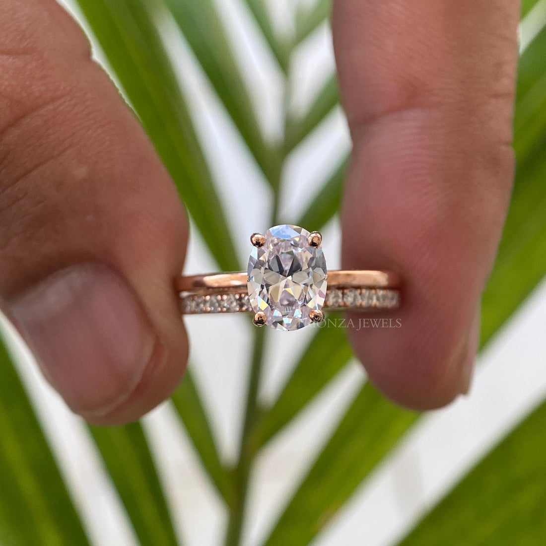Oval cut moissanite bridal set displayed in a jewelry box with flush eternity band details