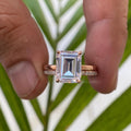 Close-up of the prong halo setting securing the 3 CT emerald cut moissanite