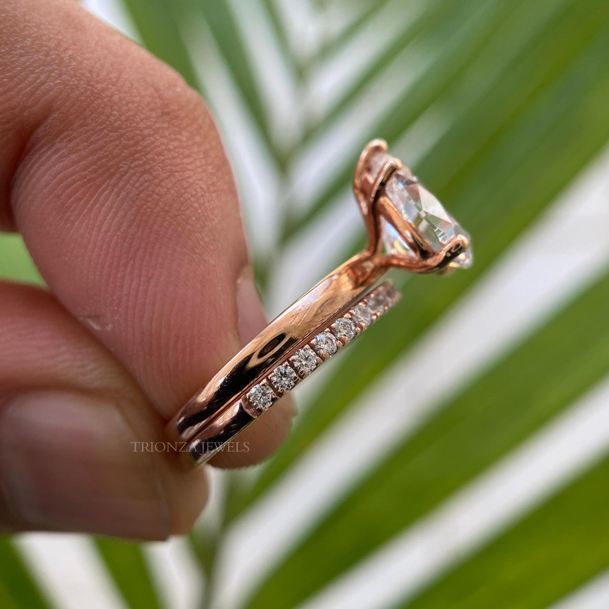 Round pave half eternity wedding band paired with a pear shaped moissanite center stone