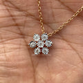 Round cut cluster pendant in 14K rose gold featuring a delicate flower shaped design