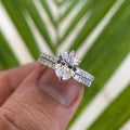 Oval moissanite bridal set featuring a flush eternity band crafted in 14K rose gold