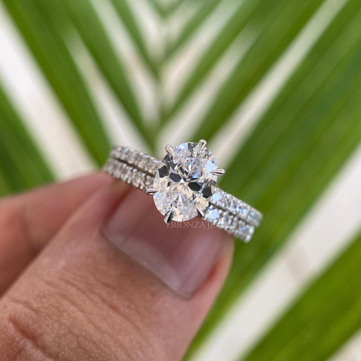 Oval moissanite bridal set featuring a flush eternity band crafted in 14K rose gold