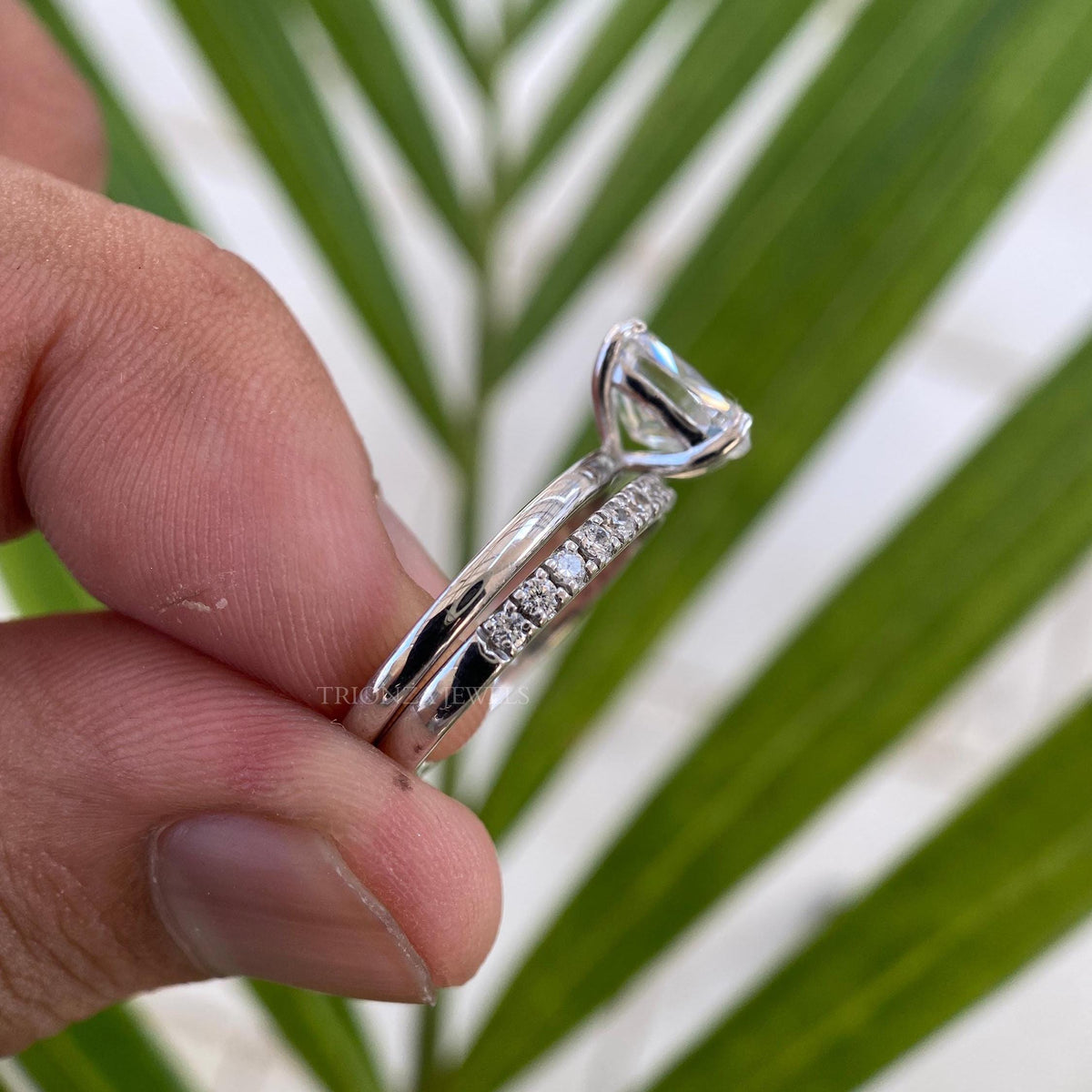 Close-up of the 2.05 CT ice crushed cushion moissanite set in a prong halo setting