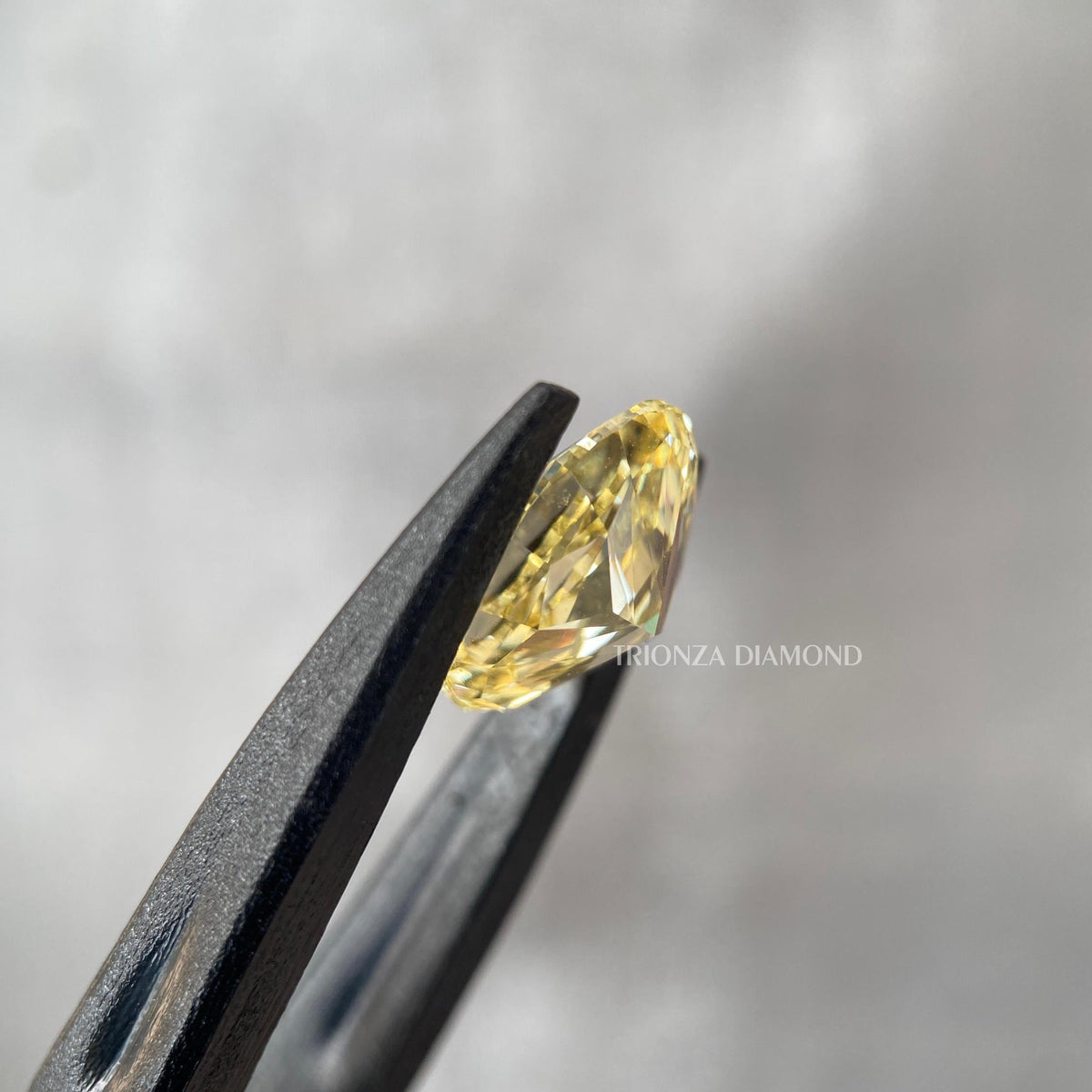 Close-up of the 1.50 CT oval yellow diamond set in a custom engagement ring design