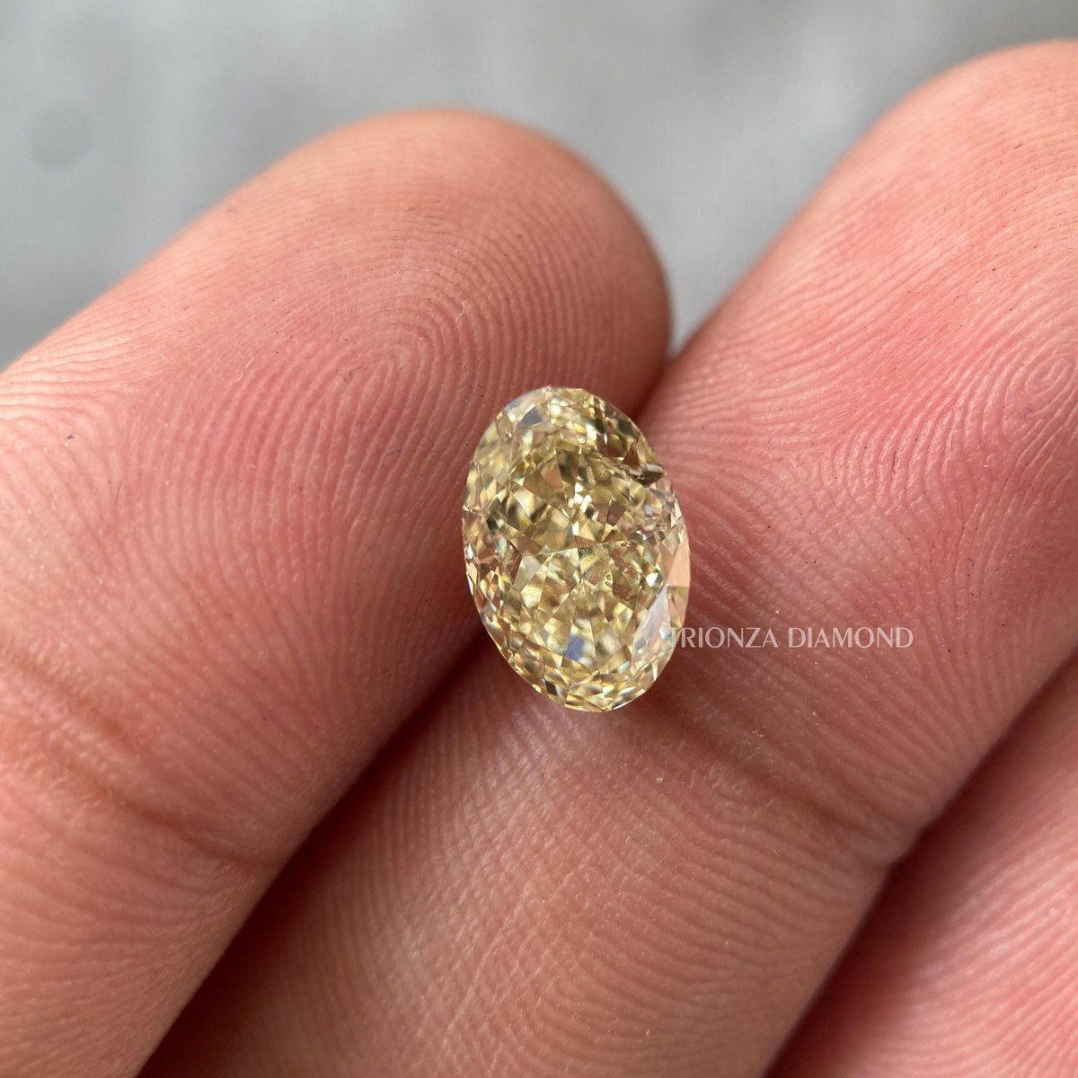 Oval cut yellow diamond engagement ring showcasing a Fancy Intense Yellow VS2 lab grown stone