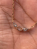 Close-up of the pear and oval cut diamonds set in a flower-inspired pendant design