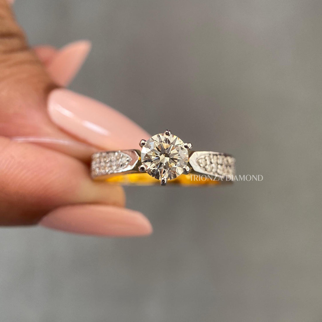 Close-up of the pave set side stones surrounding the round cut center diamond in this wedding ring