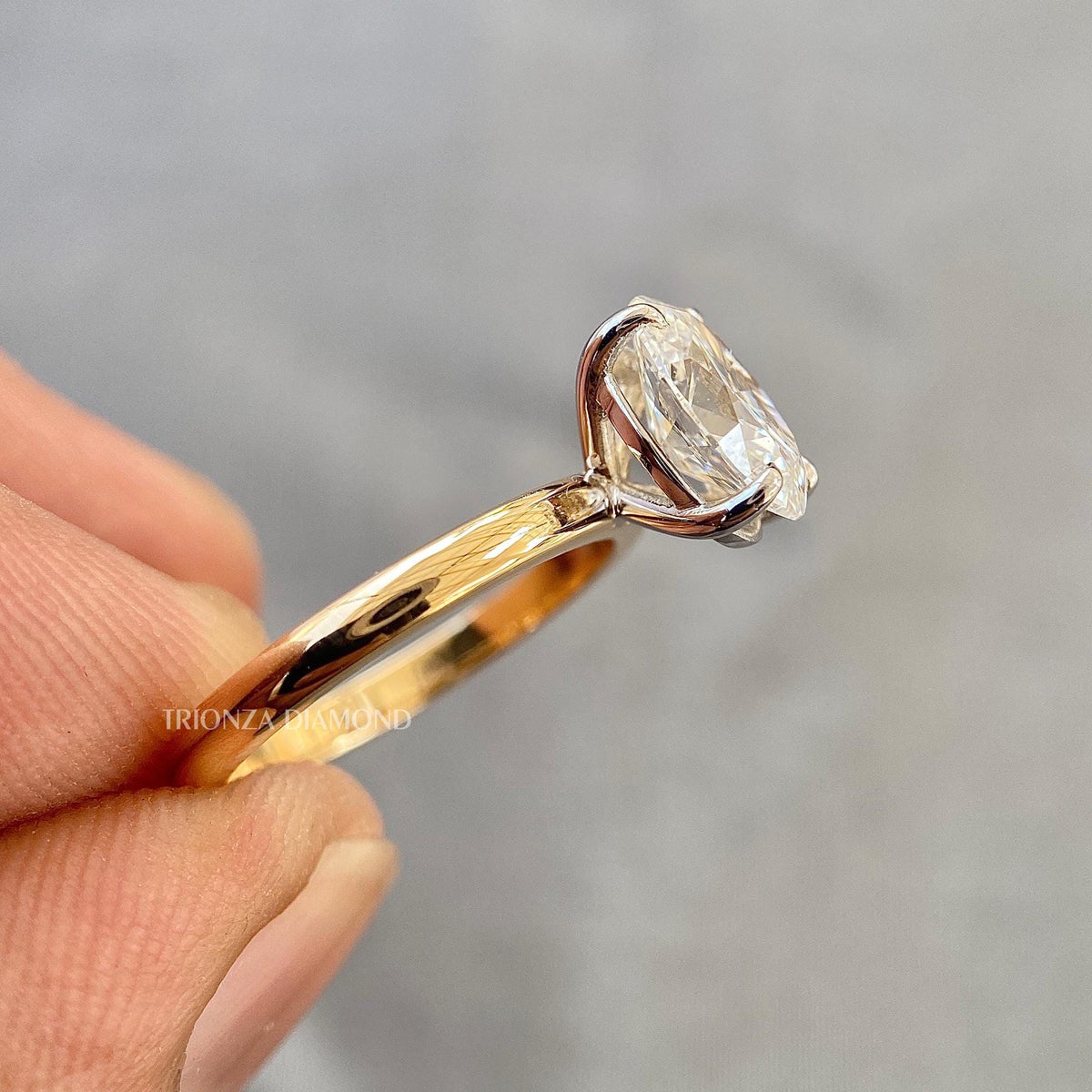Woman wearing the oval solitaire diamond ring as an anniversary gift for her