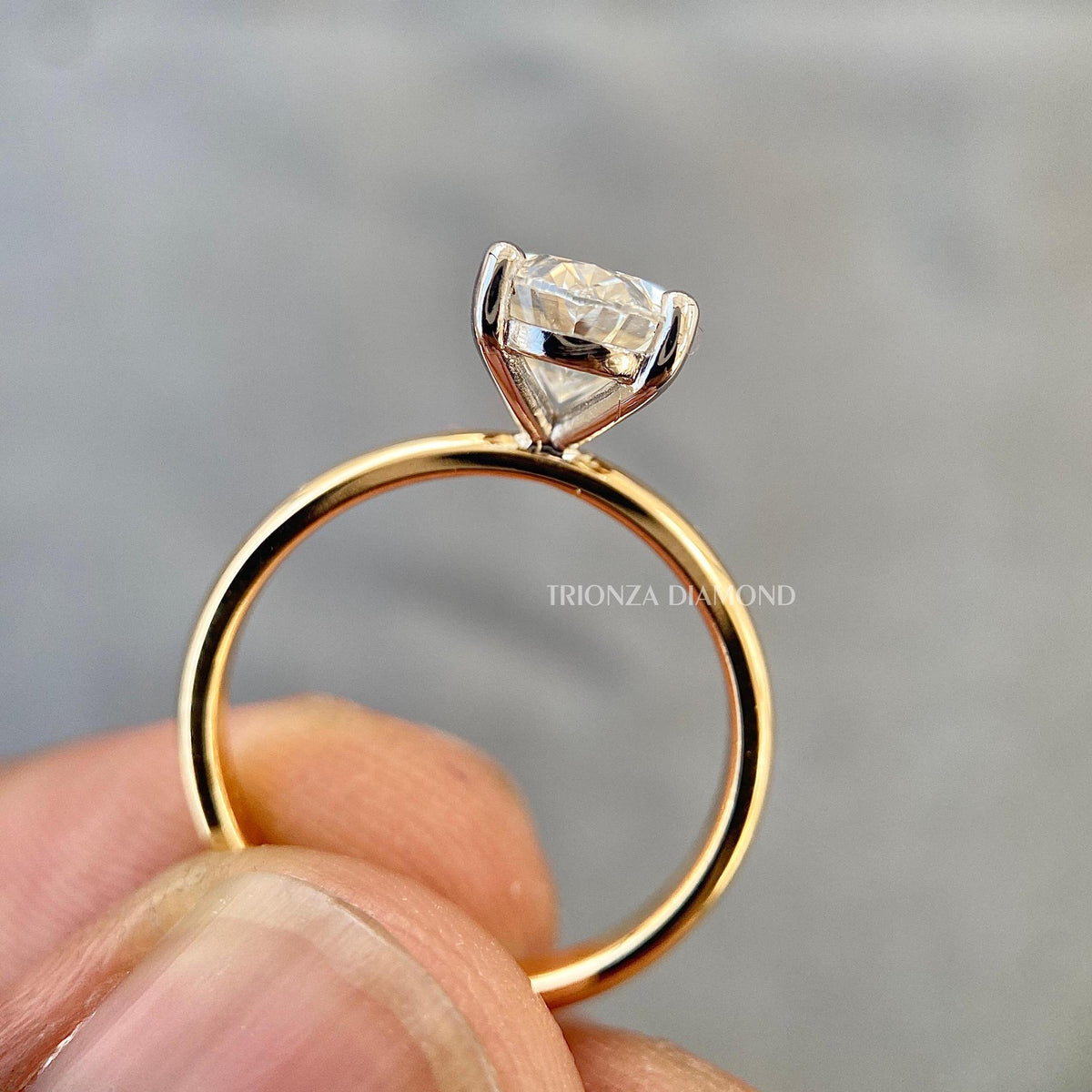 TrionzaDiamond handcrafted engagement ring featuring a cathedral set oval diamond
