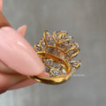 Pear and marquise cut diamonds surrounding the vivid yellow cushion cut center stone