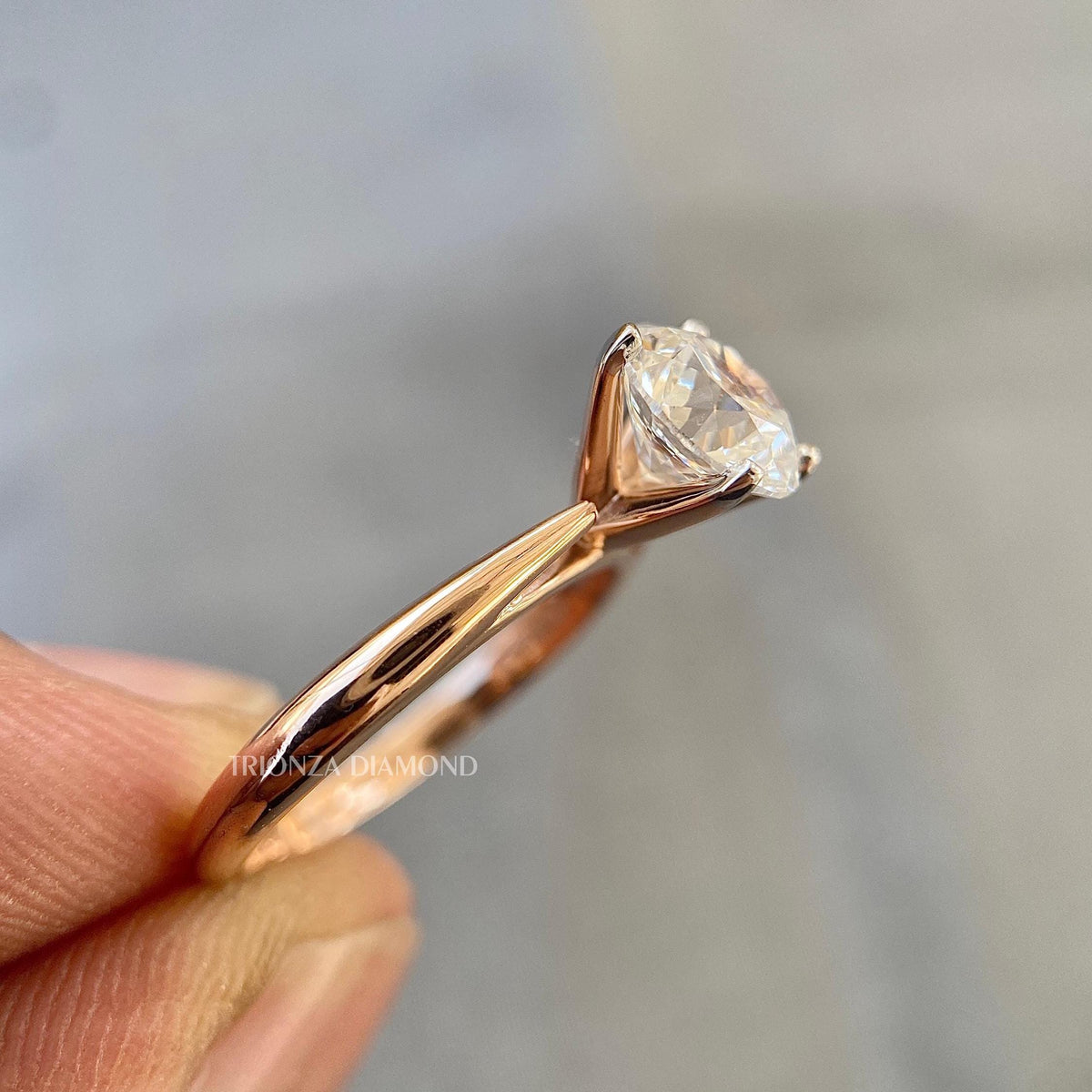 Woman wearing the round diamond solitaire ring, close-up on her hand
