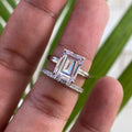 14K solid gold emerald cut moissanite wedding ring displayed in its jewelry box