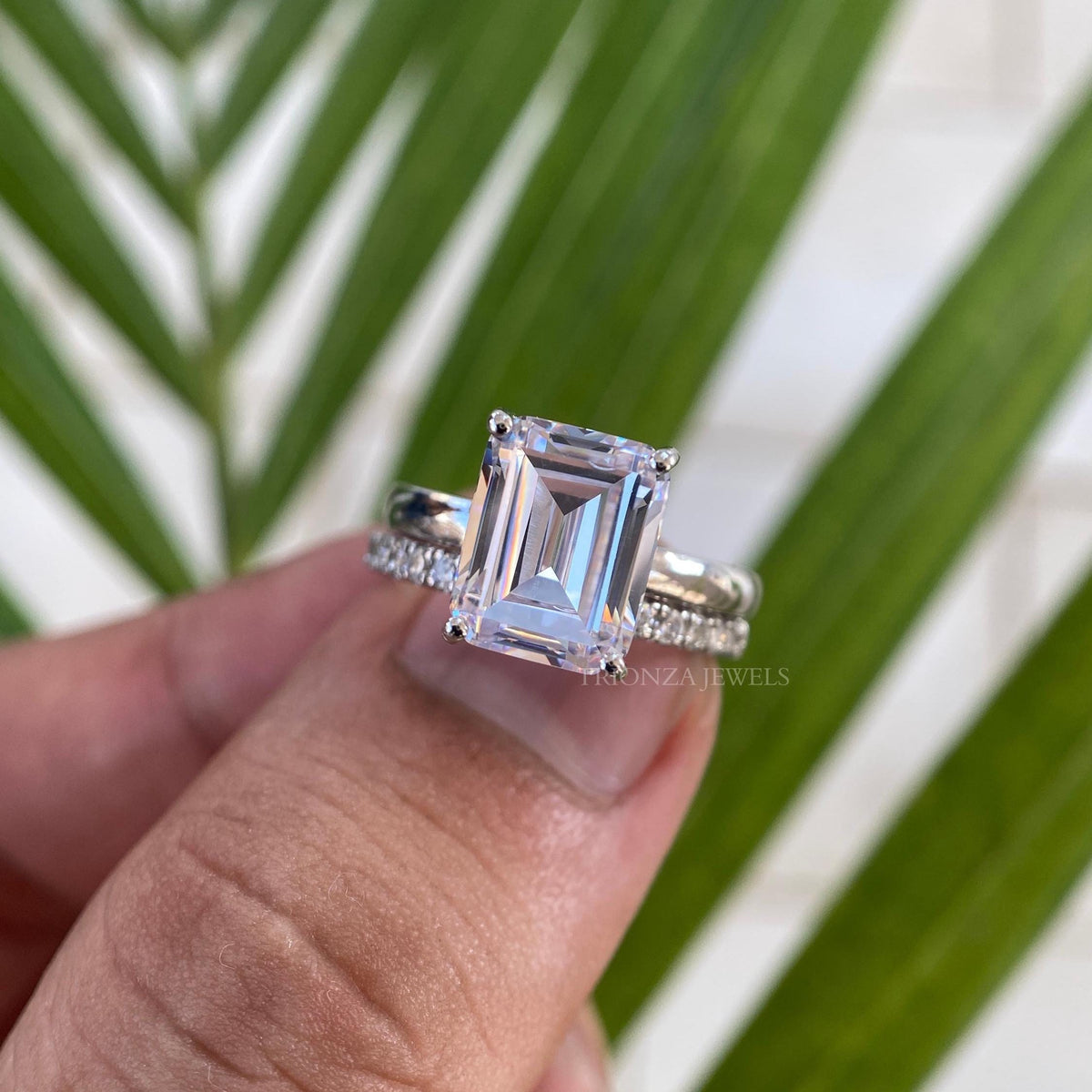 Emerald cut moissanite bridal set featuring a 3 CT D color VVS1 clarity center stone