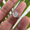 Cushion cut moissanite engagement ring displayed with its matching handmade diamond wedding band