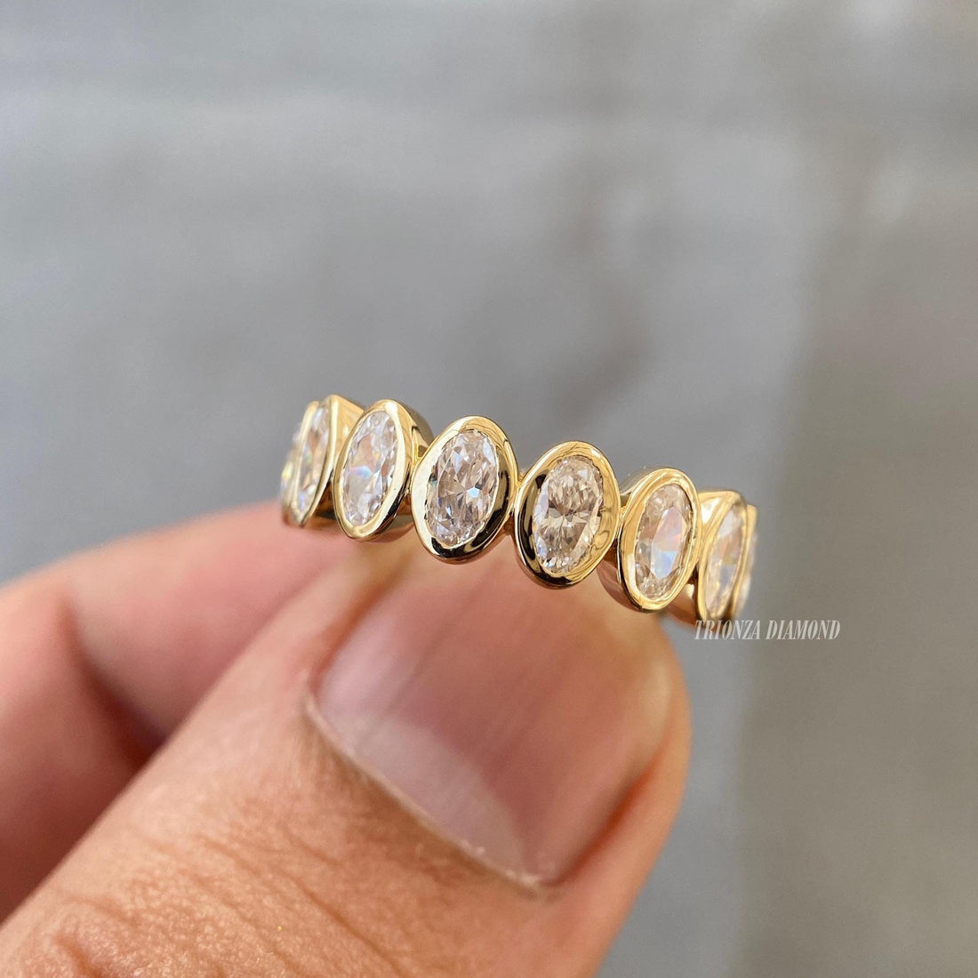 Oval cut lab diamond full eternity band bezel set in 14K yellow gold for stacking