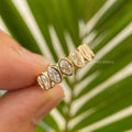Full eternity oval moissanite wedding band shown with bezel set colorless stones