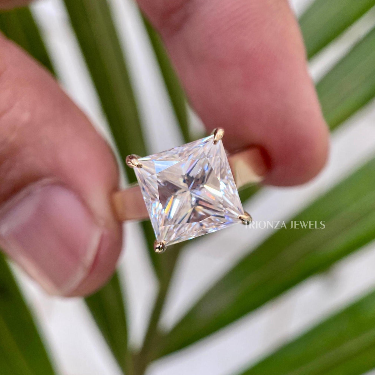 TrionzaDiamond engagement ring featuring a 4 carat princess cut moissanite centerpiece