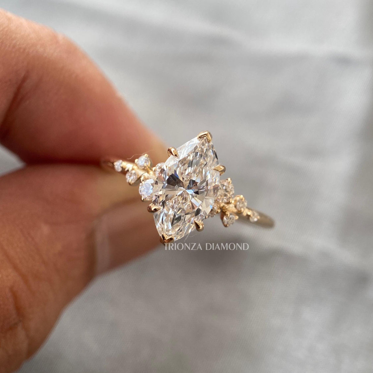 Woman wearing the marquise cut engagement ring, close-up on her hand