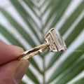 Close-up of the 5.5 CT emerald cut moissanite highlighting its colorless VVS clarity