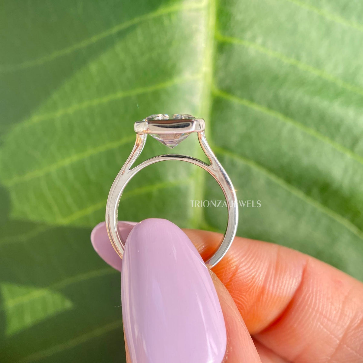 Woman wearing the emerald cut moissanite solitaire ring, shown for scale and fit