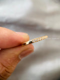 Close-up of the diamond pave setting highlighting the 0.15 CT round cut stones