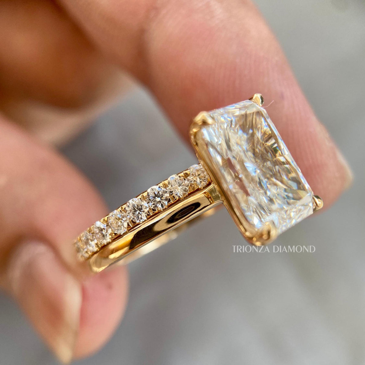 TrionzaDiamond engagement ring crafted with a 9.00 x 7.00 mm radiant cut center stone