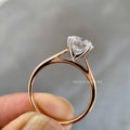 Close-up of the 4 prong setting securing the 2 carat round cut diamond